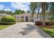 Charming home featuring a lovely paved driveway, lush landscaping, and a welcoming blue front door at 1542 Wescott Loop, Winter Springs, FL 32708