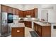 Modern kitchen features stainless appliances, breakfast bar, and ample countertop space at 1542 Wescott Loop, Winter Springs, FL 32708