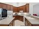 Open kitchen with modern appliances, an island, and plenty of wooden cabinets for storage at 1542 Wescott Loop, Winter Springs, FL 32708