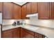 Close-up of kitchen countertop with range, appliances and cabinets for ample prep space at 1542 Wescott Loop, Winter Springs, FL 32708