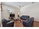 Open living room featuring hardwood floors, lots of seating, and a ceiling fan at 1542 Wescott Loop, Winter Springs, FL 32708