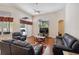 Spacious living room with hardwood floors, vaulted ceiling, and comfortable leather furniture at 1542 Wescott Loop, Winter Springs, FL 32708