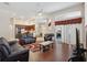 Bright living area with hardwood floors, modern furniture, and an open layout to the kitchen at 1542 Wescott Loop, Winter Springs, FL 32708