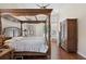 Stylish main bedroom featuring a four-poster bed, hardwood floors, a ceiling fan and ample natural light at 1542 Wescott Loop, Winter Springs, FL 32708