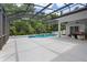 An inviting pool with a screen enclosure, waterfall feature, and plenty of patio space at 1542 Wescott Loop, Winter Springs, FL 32708