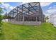 Spacious screened enclosure for outdoor entertainment, a concrete base, and lush green grass surrounds it at 1542 Wescott Loop, Winter Springs, FL 32708