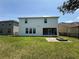 Back exterior view of the home with a patio and fire pit at 1546 Water Elm Ct, Orlando, FL 32825