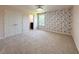 Carpeted bedroom with closet, window, and accent wall at 1546 Water Elm Ct, Orlando, FL 32825