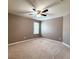 Carpeted bedroom with ceiling fan, one window and neutral color palette at 1546 Water Elm Ct, Orlando, FL 32825