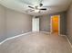 Spacious carpeted bedroom with neutral walls and a walk-in closet at 1546 Water Elm Ct, Orlando, FL 32825