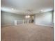 Spacious carpeted bonus room with white banister and railing and neutral color palette at 1546 Water Elm Ct, Orlando, FL 32825