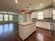 Open concept kitchen with white cabinets, granite countertops and stainless steel appliances at 1546 Water Elm Ct, Orlando, FL 32825