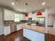 Beautiful kitchen features white cabinets, stainless appliances, granite countertops, and island at 1546 Water Elm Ct, Orlando, FL 32825