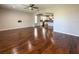 Open concept living room featuring hardwood floors and flowing to a modern kitchen at 1546 Water Elm Ct, Orlando, FL 32825