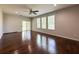 Spacious living room with hardwood floors, a ceiling fan, and sliding glass door at 1546 Water Elm Ct, Orlando, FL 32825