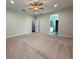 Spacious main bedroom featuring neutral carpet, ceiling fan, and ensuite bathroom at 1546 Water Elm Ct, Orlando, FL 32825