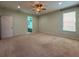 Spacious main bedroom featuring neutral carpet, ceiling fan, and ensuite bath at 1546 Water Elm Ct, Orlando, FL 32825
