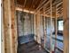 Unfinished bathroom area with wood framing, and block walls, showing plumbing fixtures at 1635 Cane Bamboo Drive, St Cloud, FL 34771