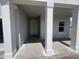 Inviting entrance with white columns at 1635 Cane Bamboo Drive, St Cloud, FL 34771