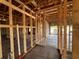 Unfinished interior with exposed wood framing and block walls, showcasing future doorway at 1635 Cane Bamboo Drive, St Cloud, FL 34771
