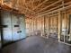 Interior view showcasing the exposed wood frame, block walls and concrete floor of the new house at 1635 Cane Bamboo Drive, St Cloud, FL 34771