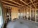 Unfinished interior with exposed wood framing and concrete flooring, and plywood at 1635 Cane Bamboo Drive, St Cloud, FL 34771
