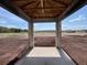 Exterior view through patio framing overlooking land with neighborhood in the distance at 1635 Cane Bamboo Drive, St Cloud, FL 34771