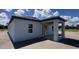 Rear exterior of home with a covered porch area showcasing ample outdoor living space at 1635 Cane Bamboo Drive, St Cloud, FL 34771