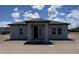 Rear view of home with covered entrance featuring a neutral exterior paint at 1635 Cane Bamboo Drive, St Cloud, FL 34771