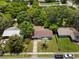 An aerial shot showcases the home's location, surrounded by lush greenery and well-maintained lawns at 167 S Sheridan Ave, Deland, FL 32720
