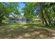 A spacious, shady backyard features a well-maintained lawn, ideal for outdoor activities and relaxation at 167 S Sheridan Ave, Deland, FL 32720