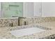 Bathroom with a granite countertop, a modern faucet, and a white sink that create a clean and stylish look at 167 S Sheridan Ave, Deland, FL 32720