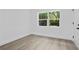 Spacious bedroom with a large window offering natural light and views, perfect for relaxation and comfort at 167 S Sheridan Ave, Deland, FL 32720