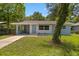 Inviting exterior view of a single-story home with a well-maintained lawn and blue accents at 167 S Sheridan Ave, Deland, FL 32720