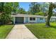 Charming single-story home with a quaint carport and lush green lawn at 167 S Sheridan Ave, Deland, FL 32720