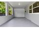 A bright, clean garage features block wall construction, multiple windows, and a rear entry door at 167 S Sheridan Ave, Deland, FL 32720