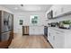 Modern kitchen with stainless steel appliances, quartz countertops, and white cabinets at 167 S Sheridan Ave, Deland, FL 32720