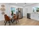 Eat-in kitchen with stainless steel appliances, white cabinetry, and modern fixtures at 167 S Sheridan Ave, Deland, FL 32720