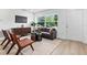 Cozy living room with stylish seating, a media console, and plenty of natural light at 167 S Sheridan Ave, Deland, FL 32720