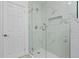 Modern tiled shower with glass door and a recessed shelf, offering a sleek and functional bathing experience at 167 S Sheridan Ave, Deland, FL 32720