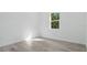 Bright bedroom with luxury vinyl plank flooring and a window with treetop views at 17 Cypress Run, Haines City, FL 33844