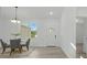 Bright dining area features modern table set, wood flooring, and natural light at 17 Cypress Run, Haines City, FL 33844