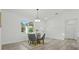Well-lit dining area offers neutral decor, modern lighting, and access to other rooms at 17 Cypress Run, Haines City, FL 33844