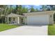Front exterior showcasing the home's architectural style and well-manicured yard at 17 Cypress Run, Haines City, FL 33844
