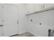 Clean and functional laundry area with overhead cabinets for storage and easy access at 17 Cypress Run, Haines City, FL 33844