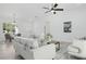 Bright living room features an elegant ceiling fan and stylish decor, perfect for relaxation at 17 Cypress Run, Haines City, FL 33844