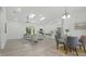 Open living space with dining area, modern furniture, and abundant natural light at 17 Cypress Run, Haines City, FL 33844