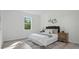 Calm main bedroom featuring a large window, neutral decor, and wood-look flooring at 17 Cypress Run, Haines City, FL 33844