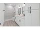 Modern bathroom showcasing double sinks, sleek fixtures, and a beautifully tiled walk-in shower at 17315 Sw 26Th Terrace Rd, Ocala, FL 34473