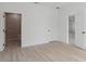 Bedroom featuring light wood floors and an ensuite bathroom at 17315 Sw 26Th Terrace Rd, Ocala, FL 34473
